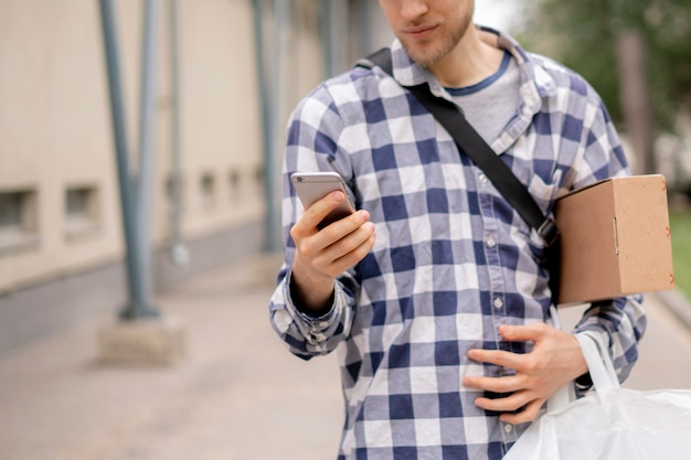 courier using phone searching address path deliver packages 63762 192