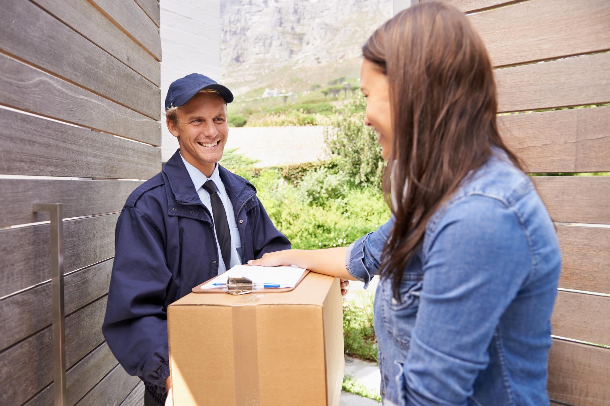 i always use trustworthy courier shot friendly delivery man delivering package young woman 590464 23